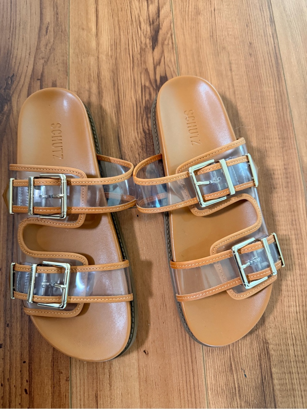 SCHUTZ Tan Slide Sandals with Clear Straps and Gold Buckles
